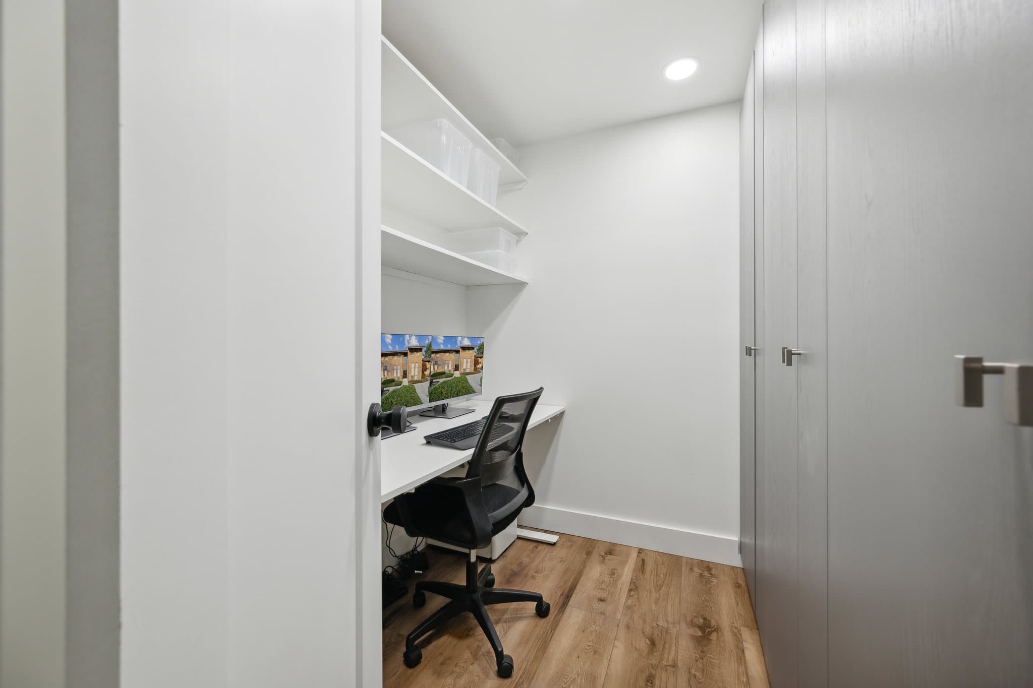 Closet office with shelving desk and tall cabinets