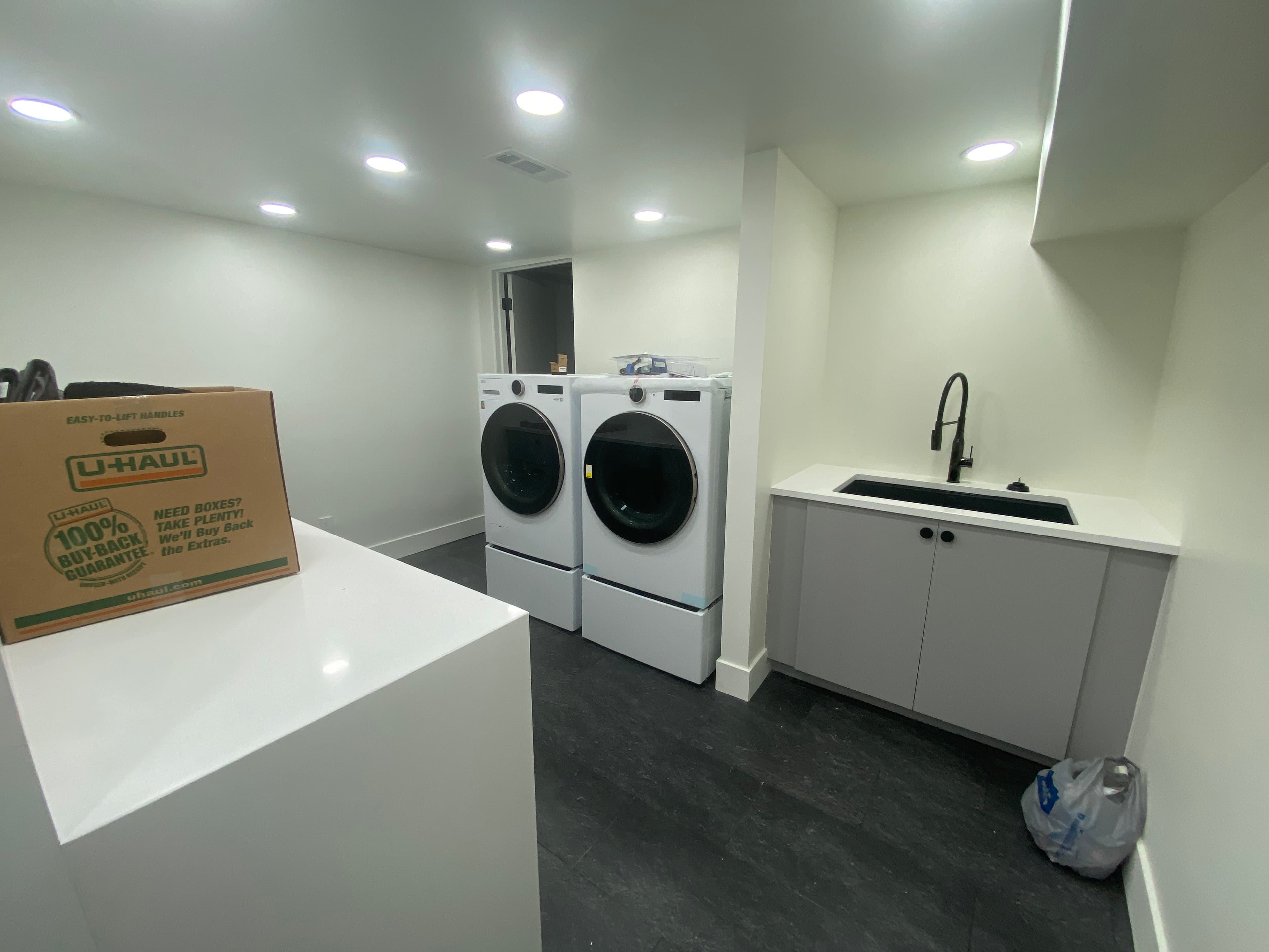 Laundry room with gray utility cabinetry and sink