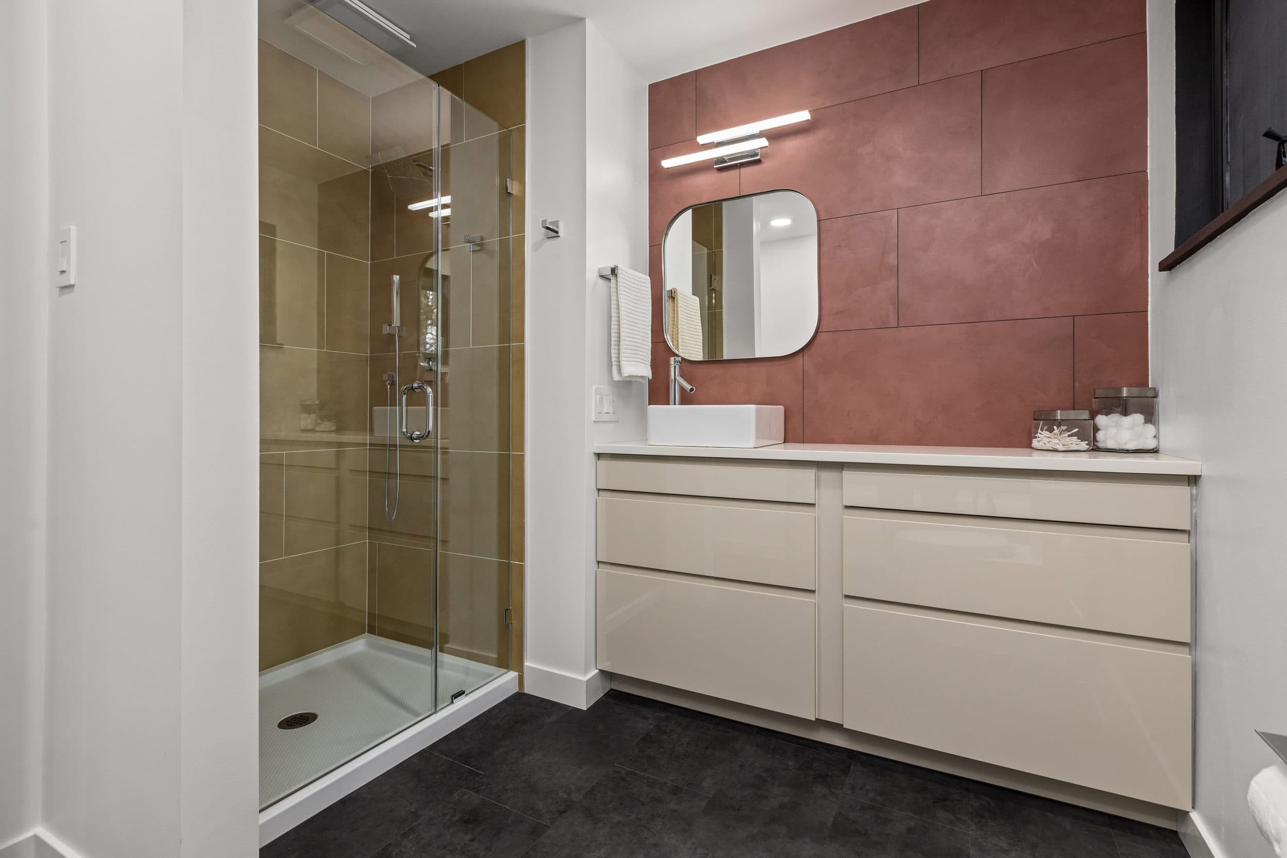 Neutral bathroom vanity with warm accent wall