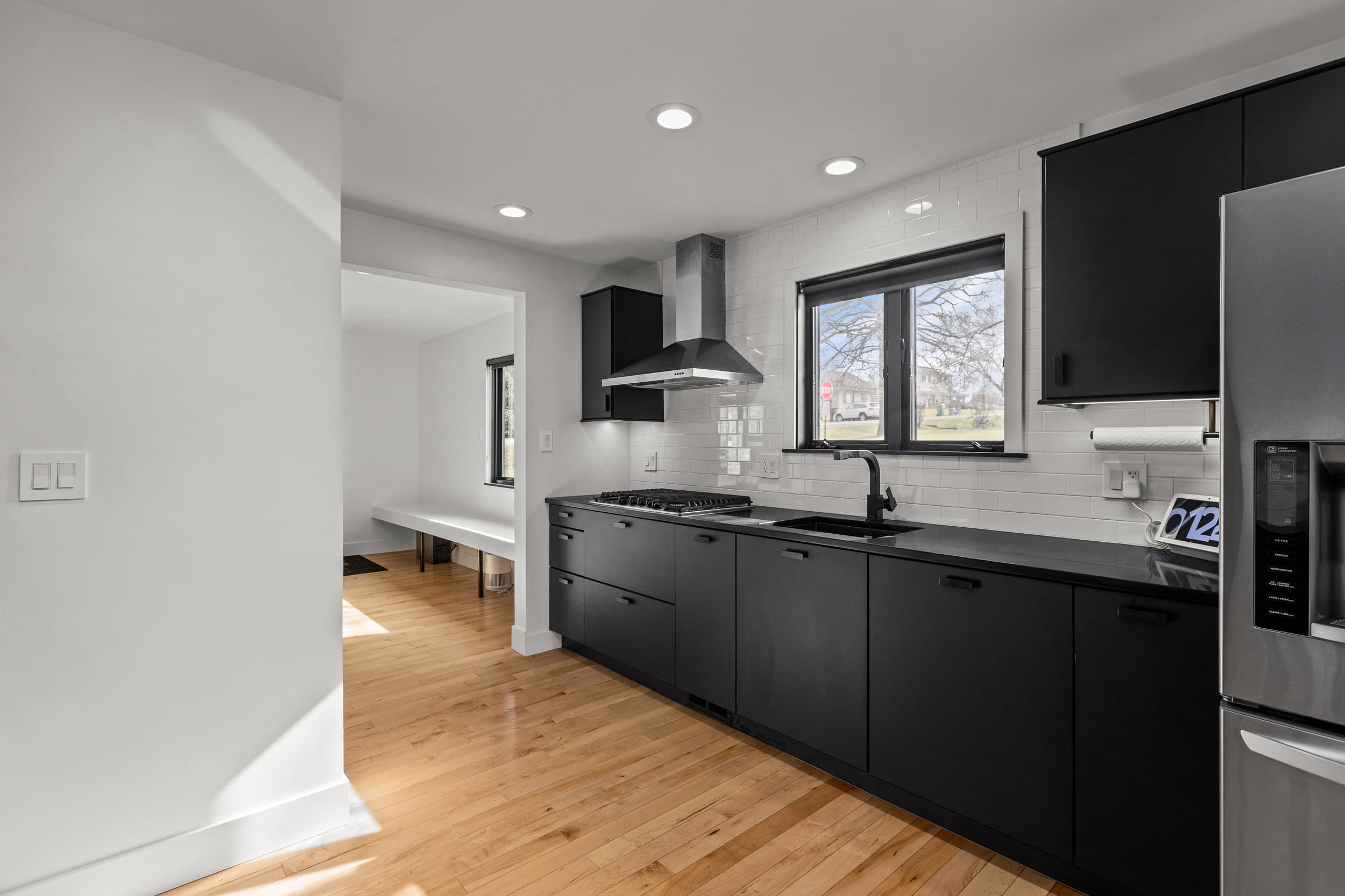 Matte black kitchen cabinetry with white subway tile