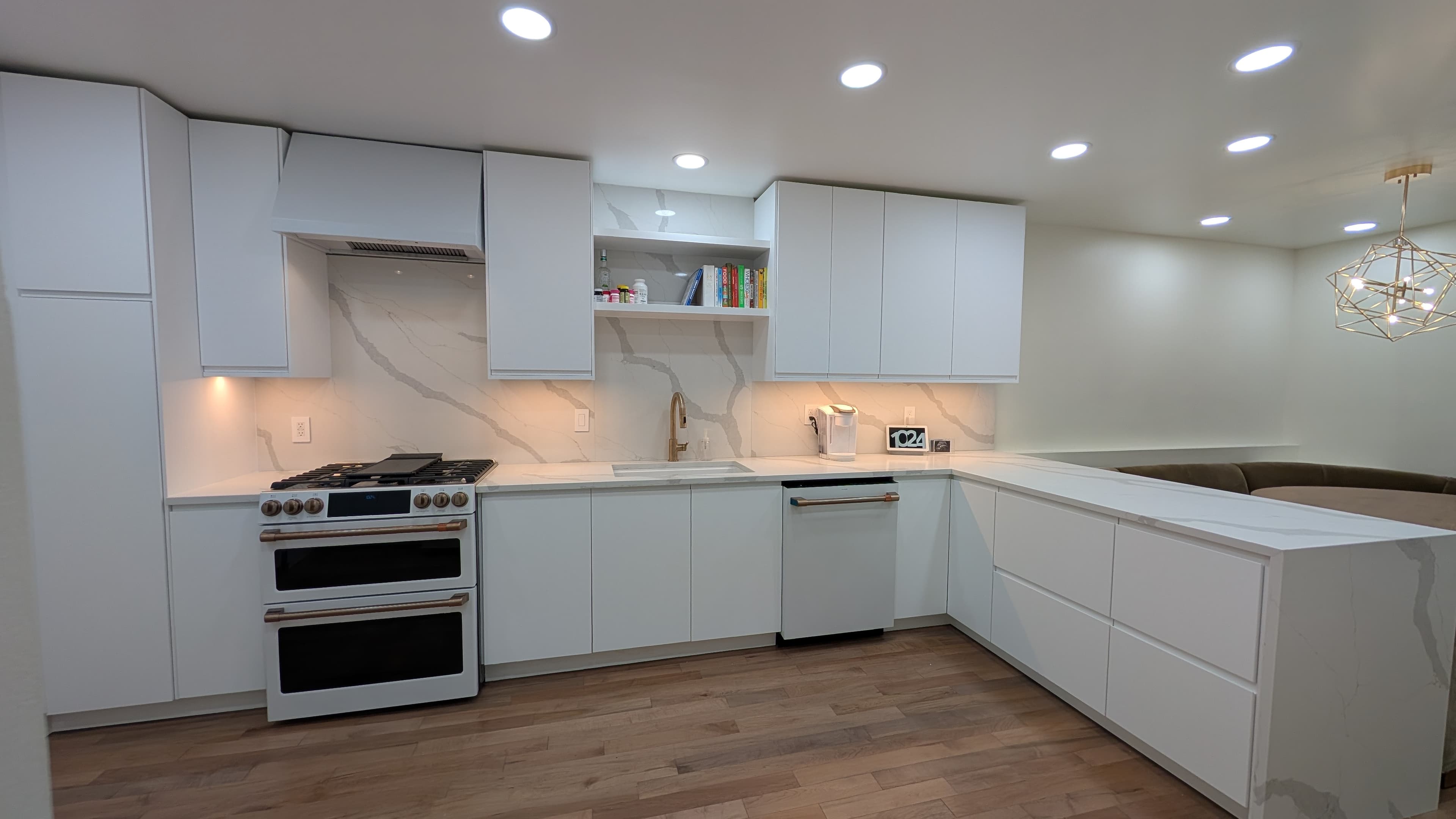 Bright white kitchen with integrated cabinetry and peninsula
